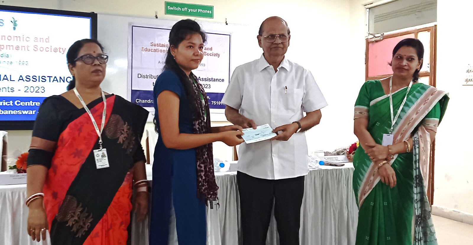 Scholarship financial aid cheque handed over to student
